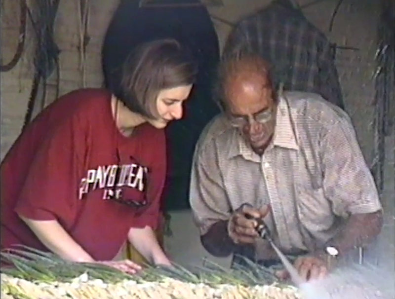 Tim showing Mary how to clean scallions